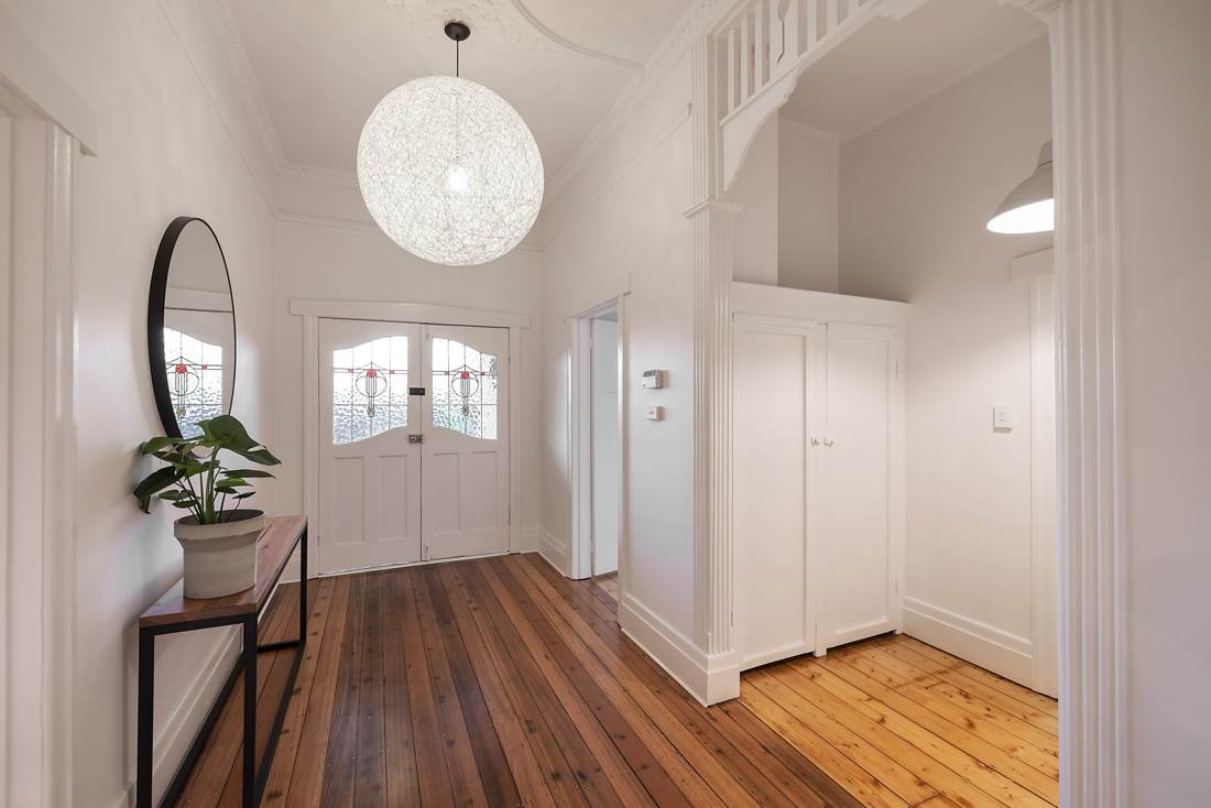 Restored entry hall with fretwork arch, leadlight doors and polished baltic pine floors