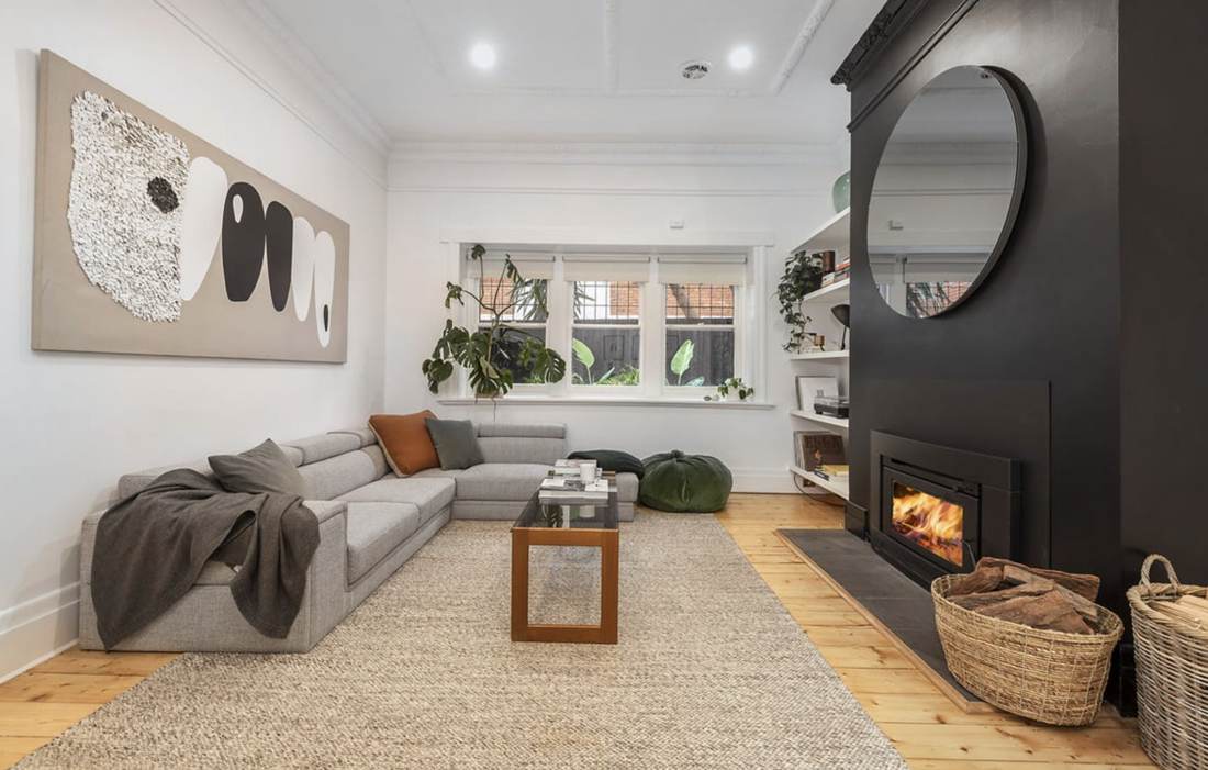 Lounge with black fireplace wall, inbuilt wood fire and ornate plaster ceiling