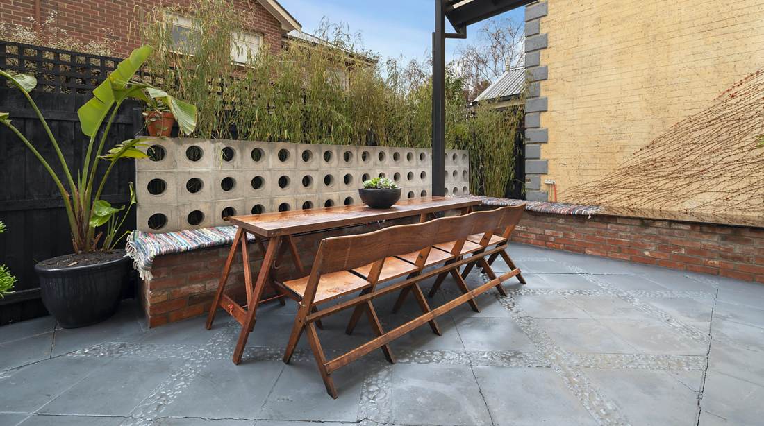 Rear courtyard with breeze block wall, recycled brick seat and bluestone paving