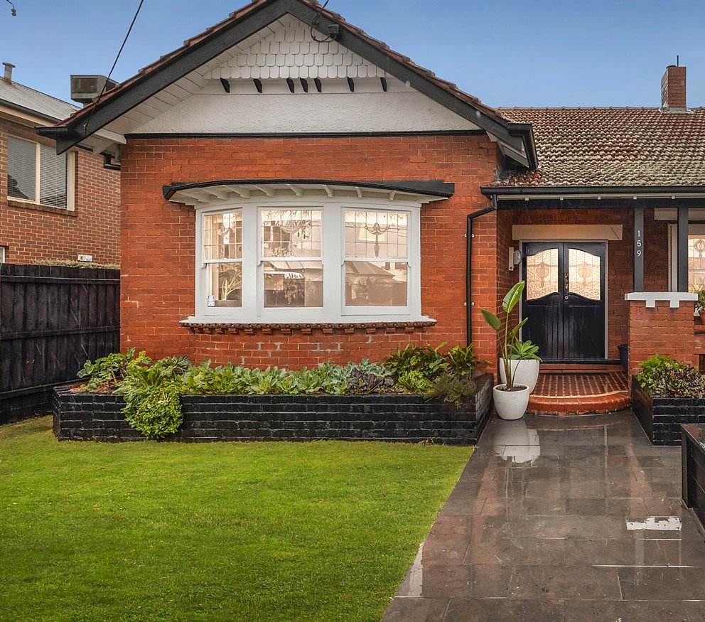 Finished front garden — vegetables in the black raised bed beneath the bay window, lawn and path complete