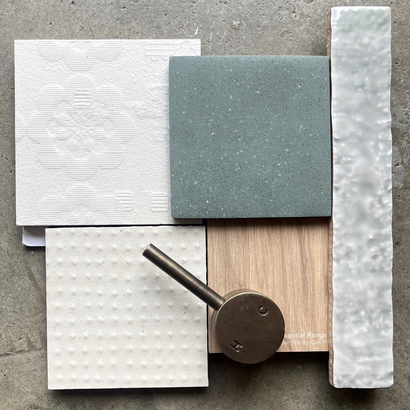 Palette detail — cool greens and greys in stone, linen and tile with aged brass