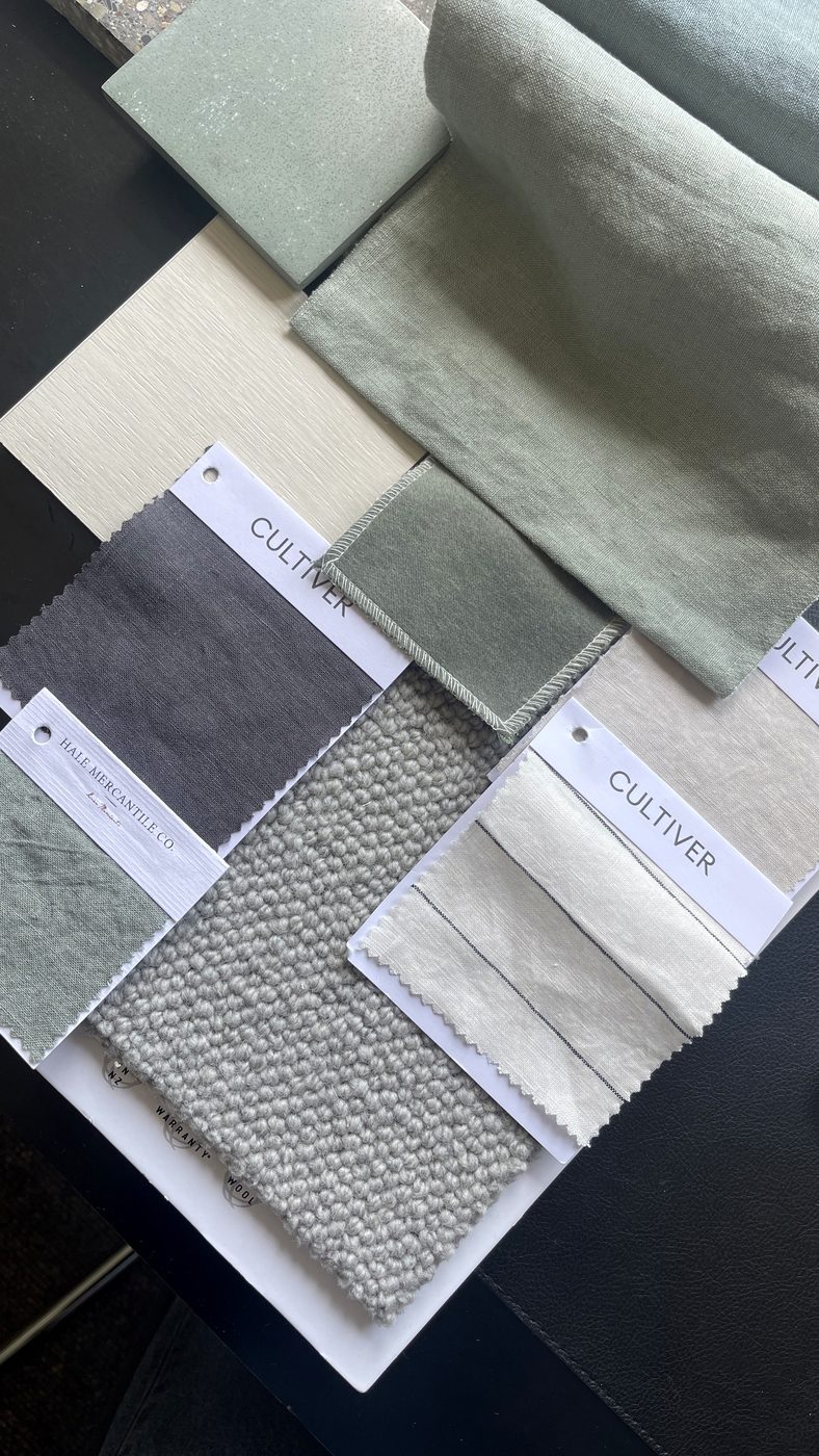 Palette detail — layered linens and wool against sage stone and patterned fabric