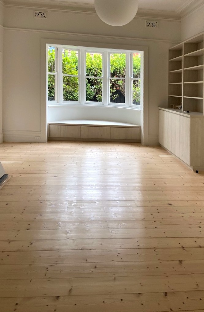 The bay window — a window seat built into new grey-washed timber joinery beneath the restored bay