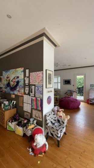 The living area before the work — the wall where the new fireplace now sits