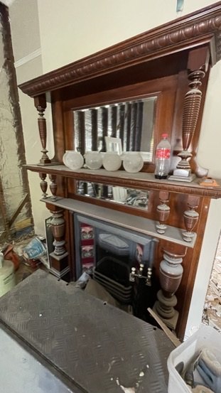 The original timber overmantel mid-works, surrounded by site dust