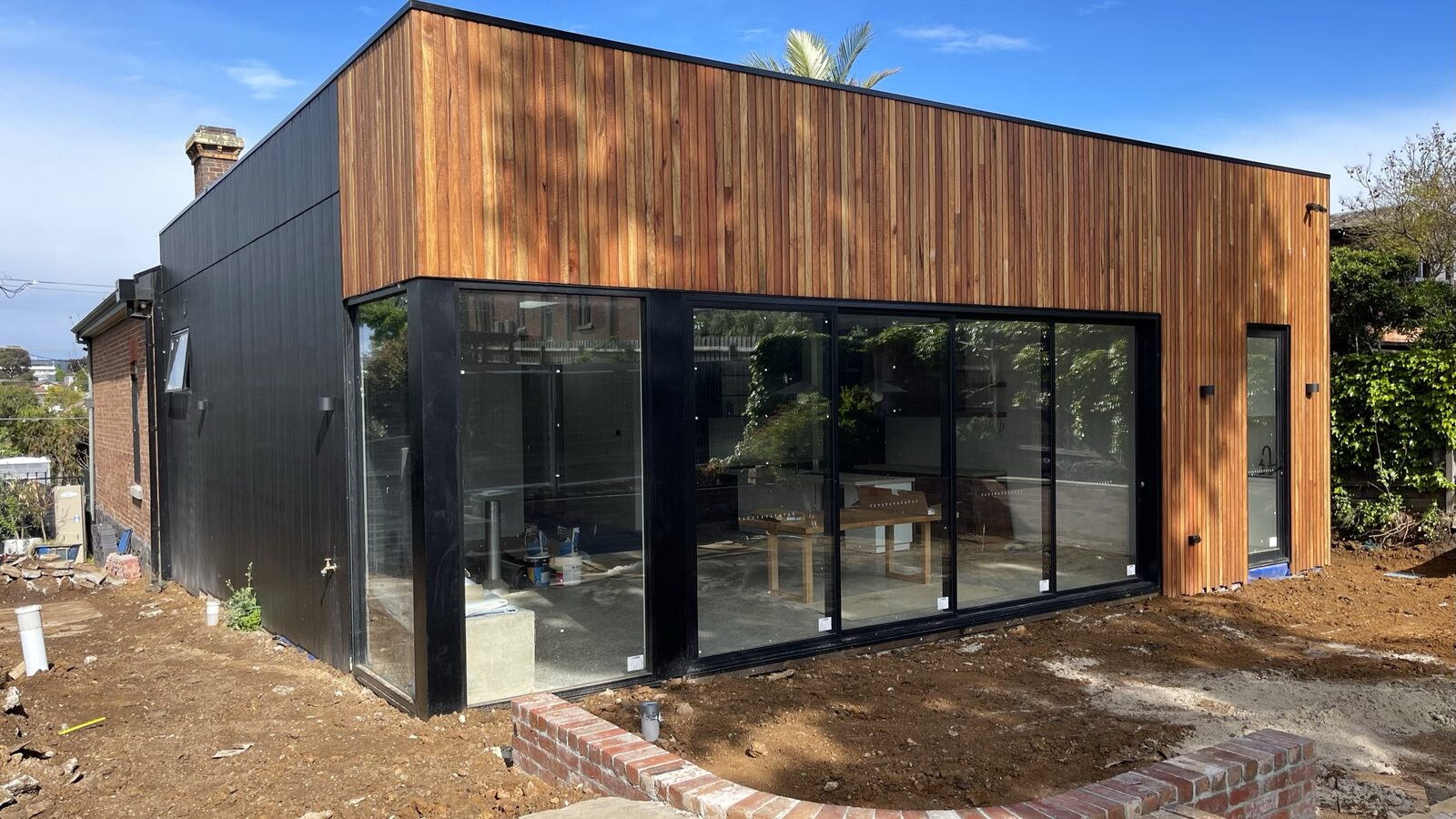 Waverley House — the new rear extension in vertical spotted gum cladding and black-framed glazing